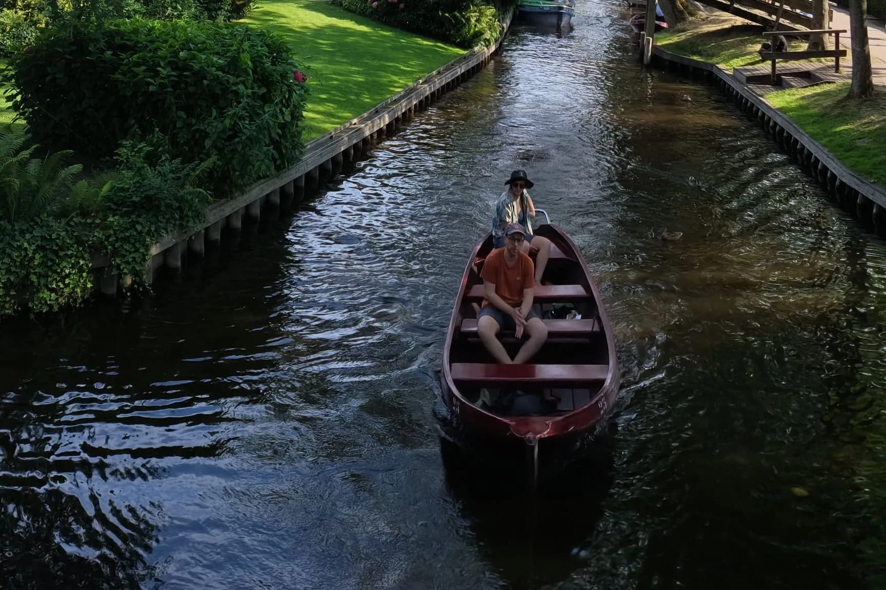 Boat on a canal beneath trees in Giethoorn, Netherlands