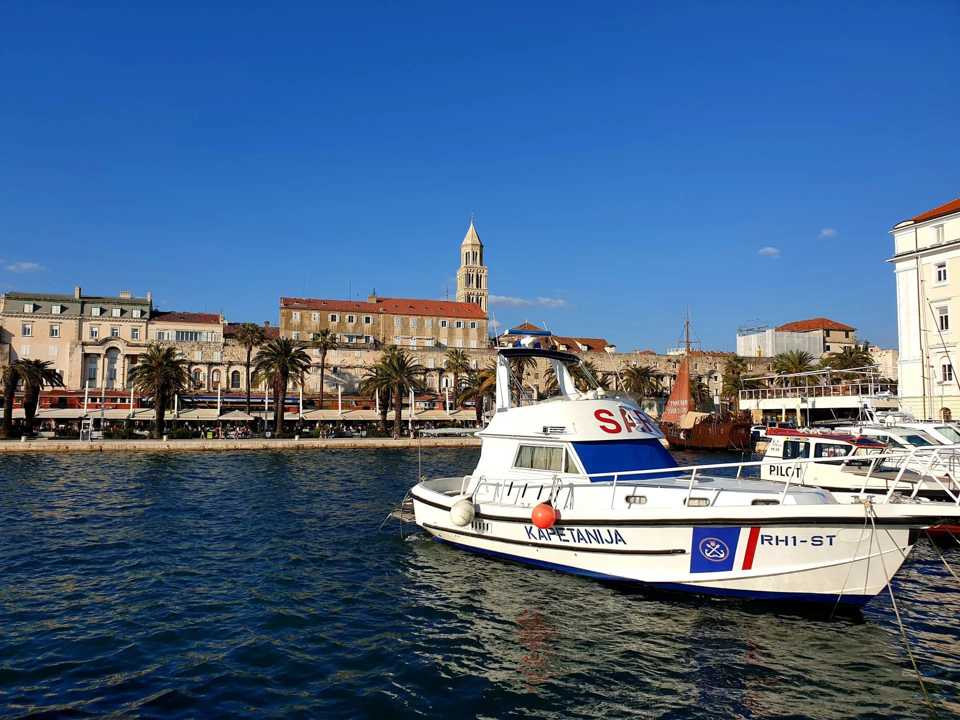 Harbor boats and palm-lined waterfront in Split, Croatia