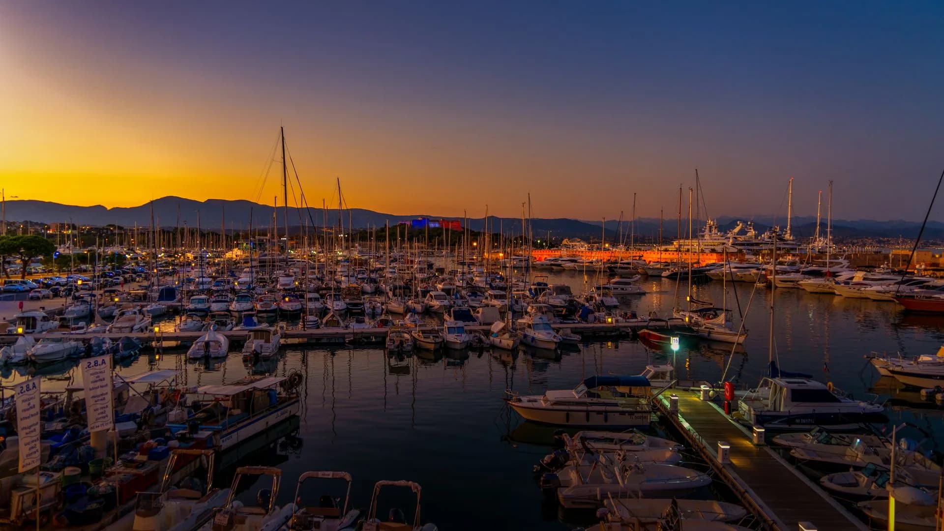 Sunset over moored boats in Antibes marina, France