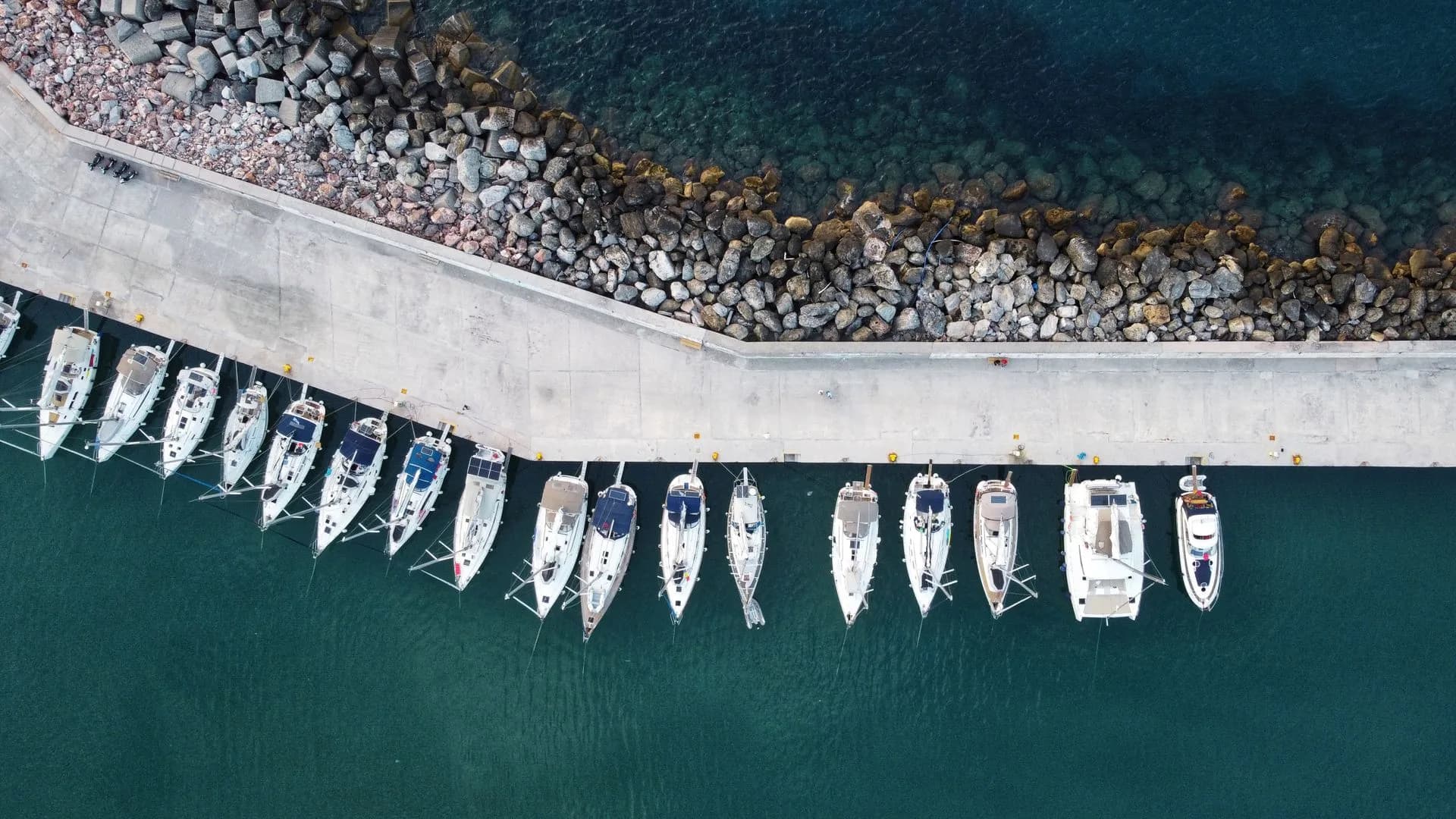 Yachts moored at a pier in Skopelos harbor, Greece