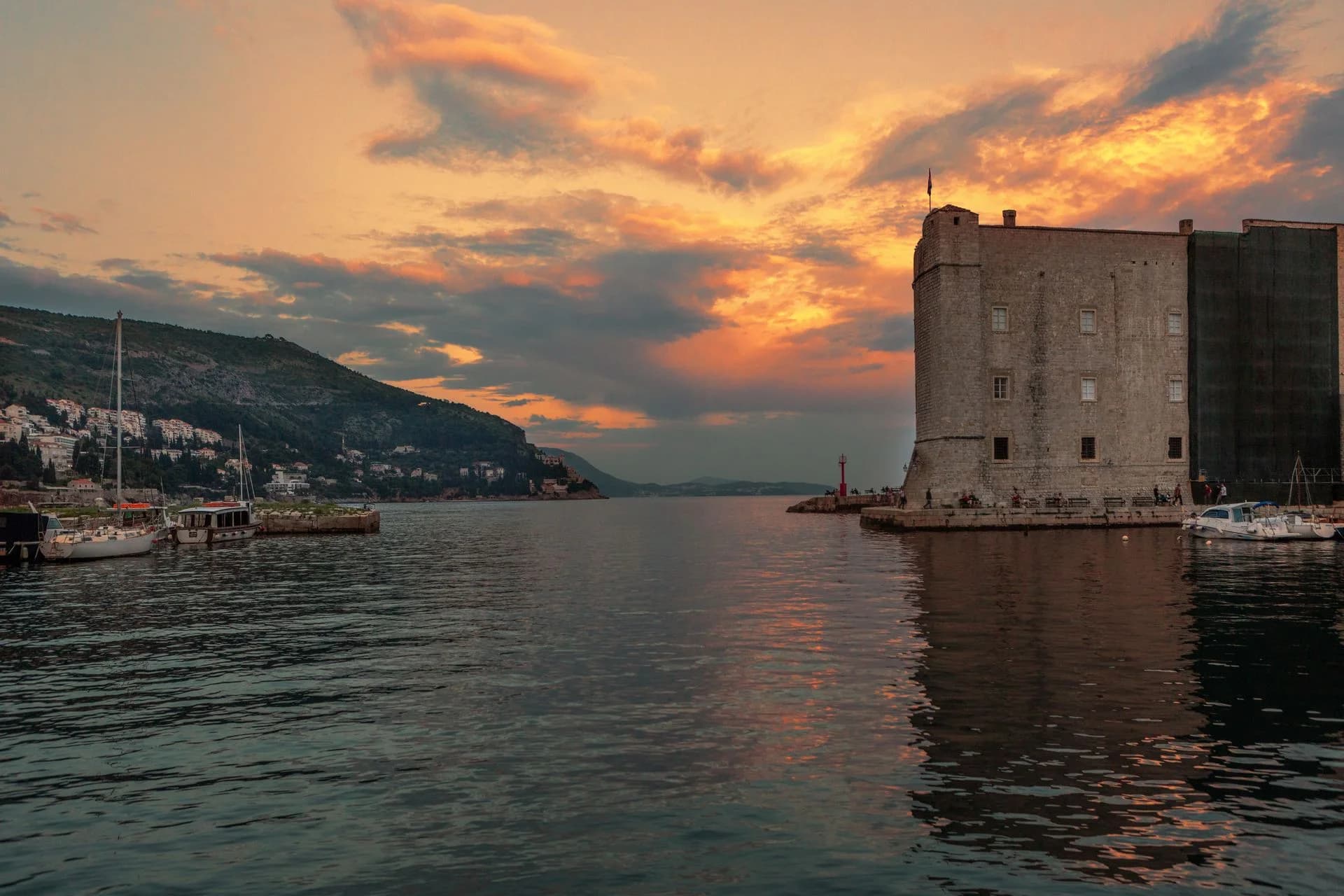 Sailboats and waterfront architecture at sunset in Dubrovnik, Croatia
