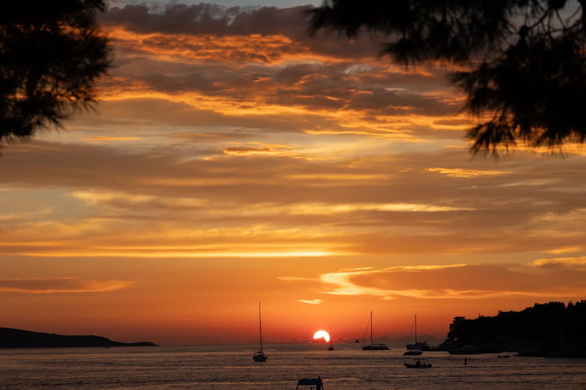 Sailboats in a bay at sunset in Hvar, Croatia