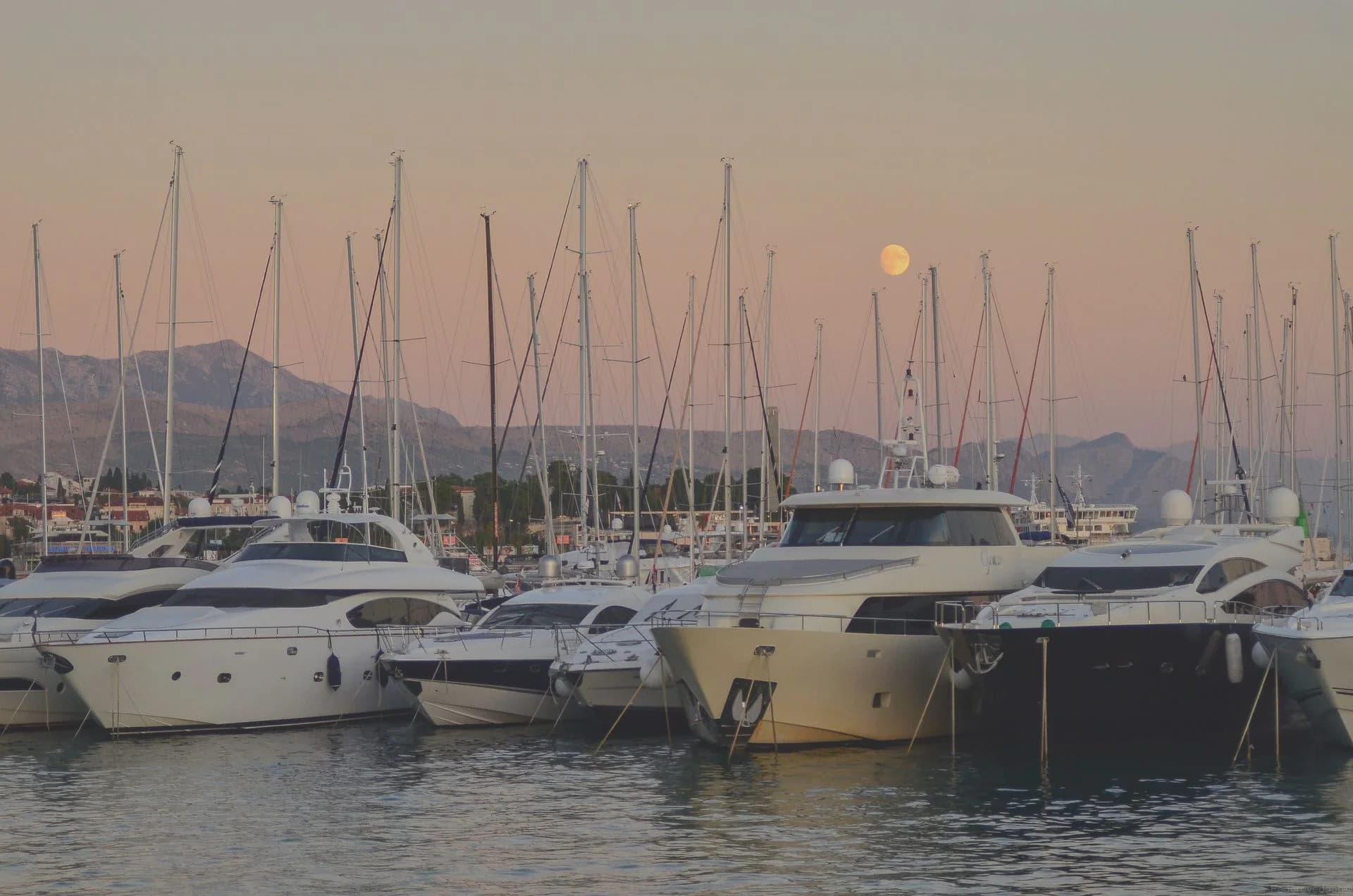 Yachts docked at sunset with mountains behind Split, Croatia