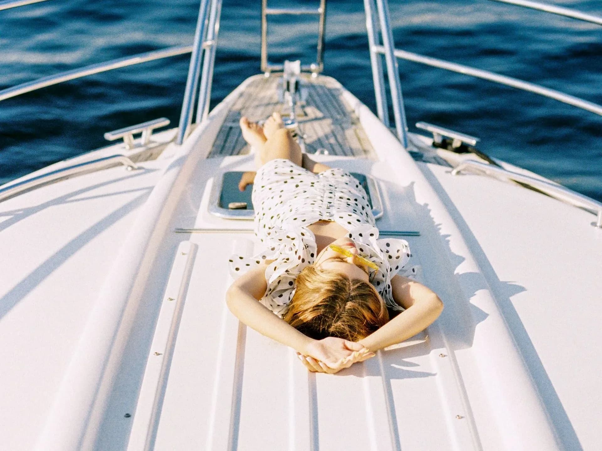 A woman relaxing on a yacht deck.