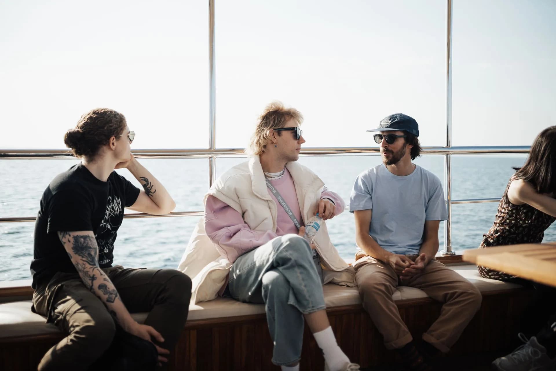 Friends seated together on the deck of a boat.