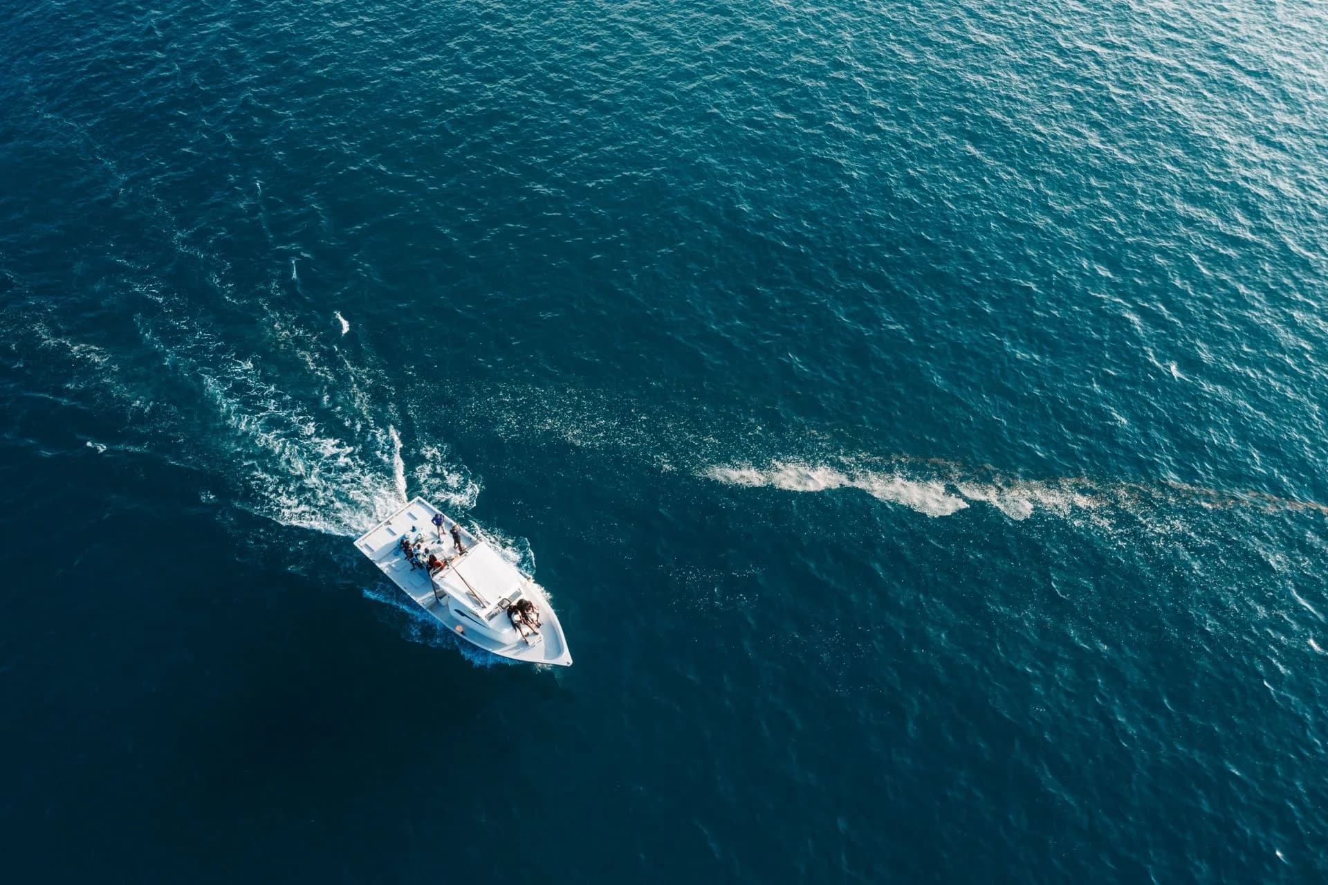 A motorboat leaving a wake on open water.