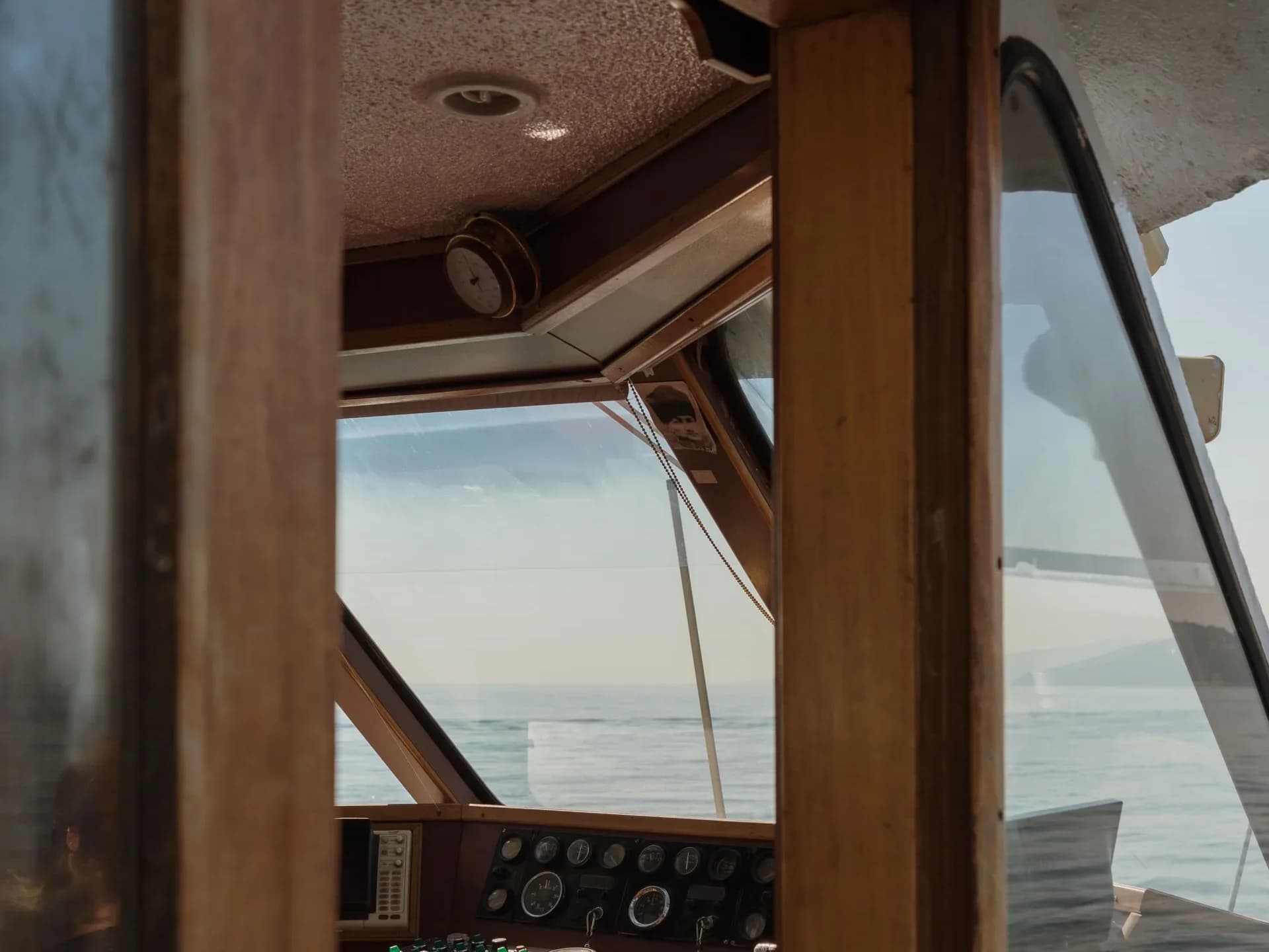A yacht helm and console overlooking the water.