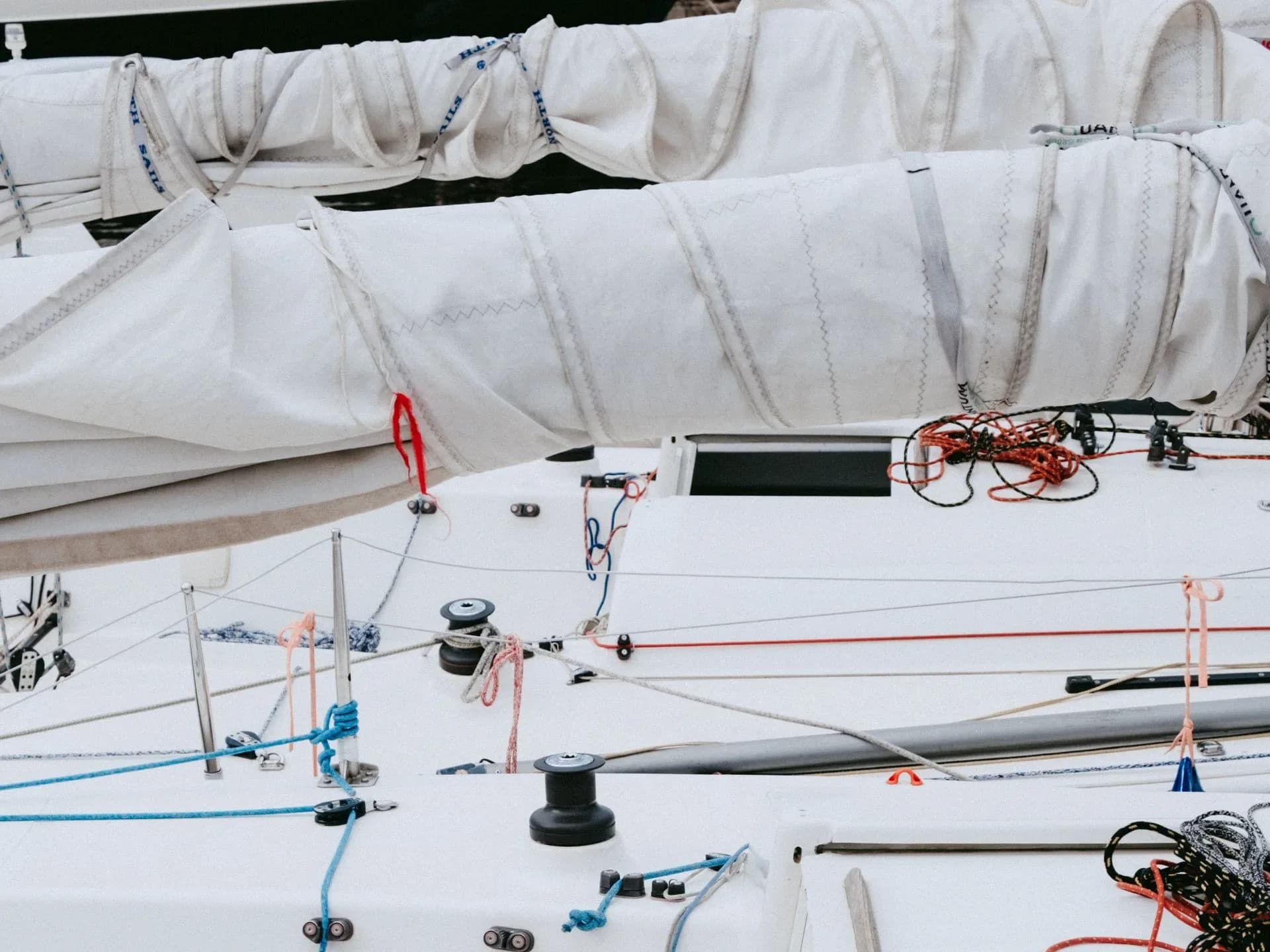 Ropes and rigging arranged on a sailing yacht deck.