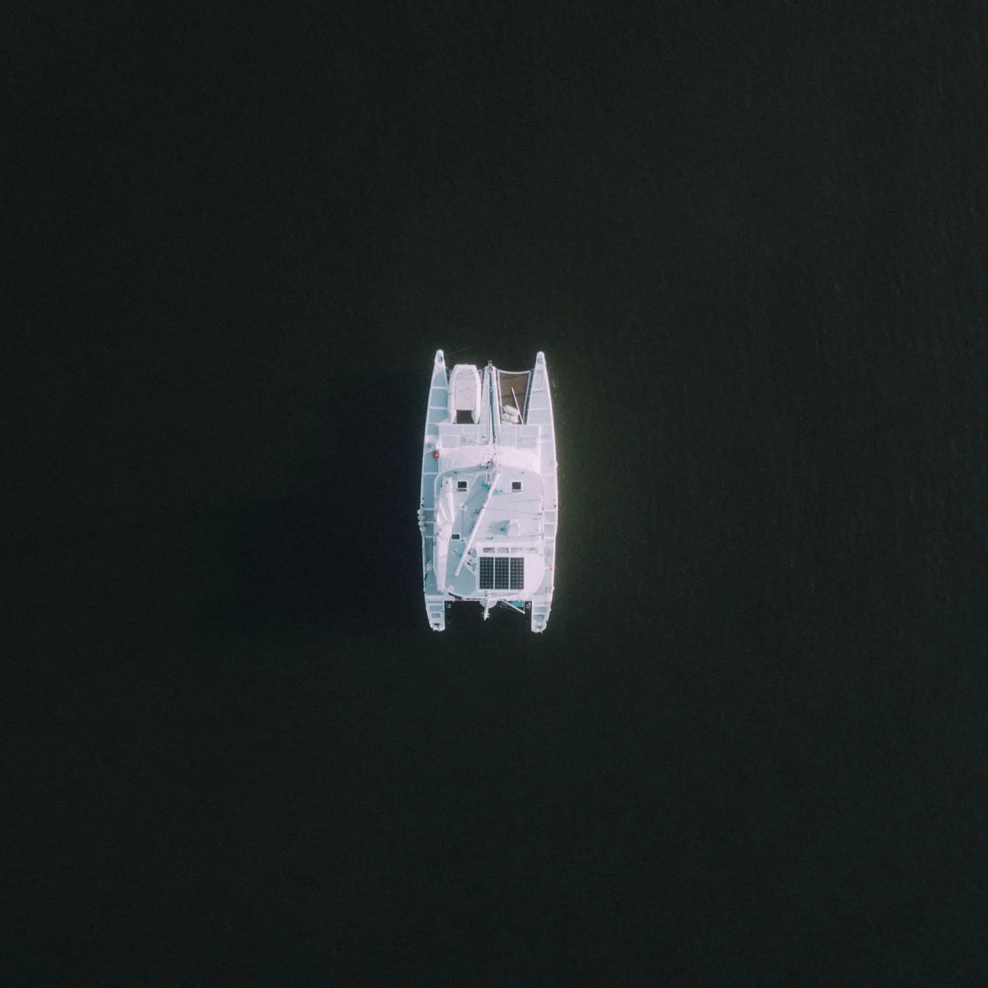 Overhead view of a catamaran on open water.