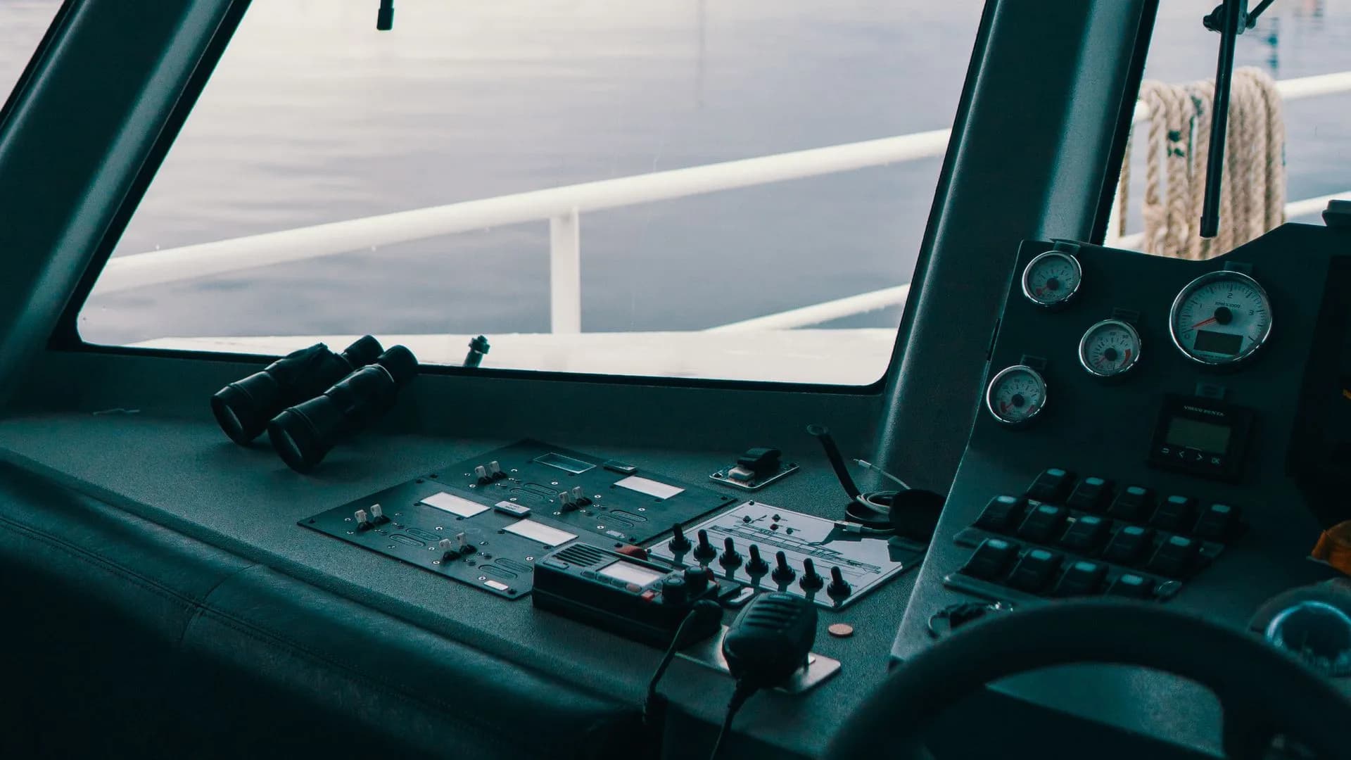 Boat helm controls and binoculars.